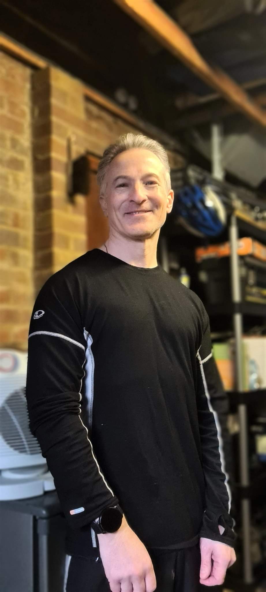 David Gordon smiling in a black fitness top
