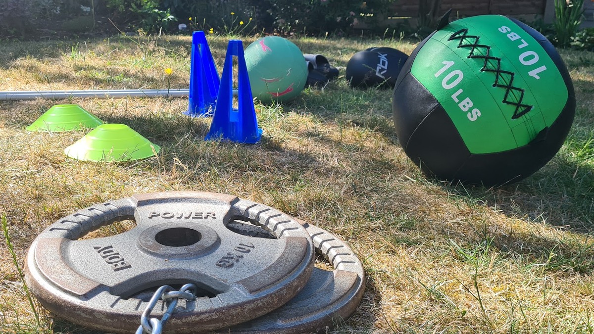 Outdoor fitness equipment including weighted plates and a medicine ball